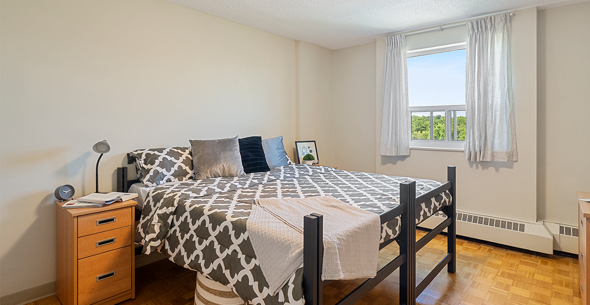 Bedroom showing bed, side table and window