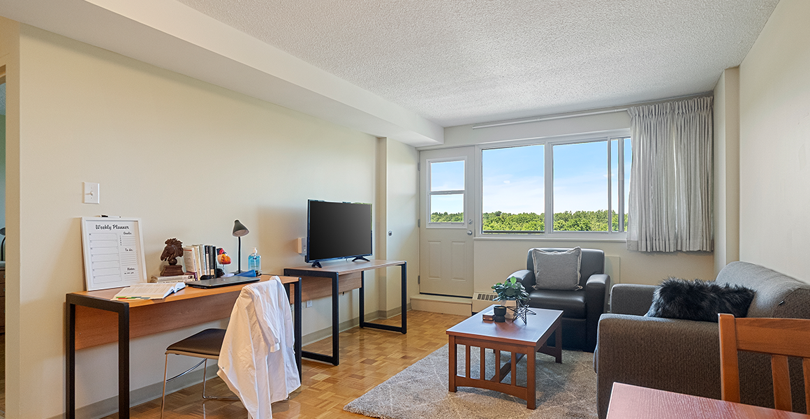 Living room showing couch, chair and TV stand