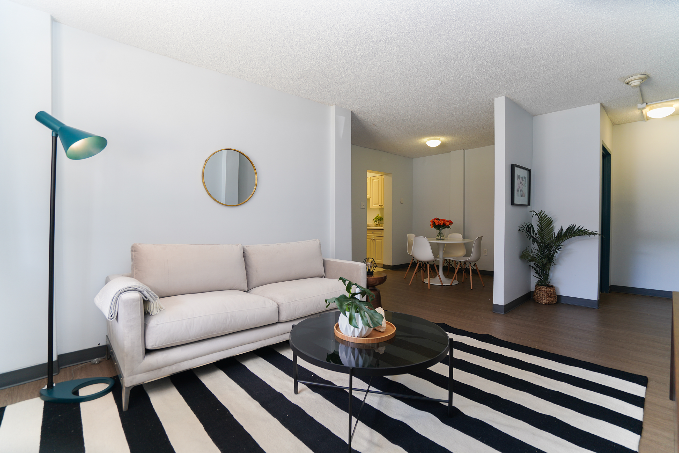 Living room show cable table, couch and looking towards dining area