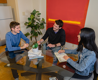 Three tenants sitting around dining table