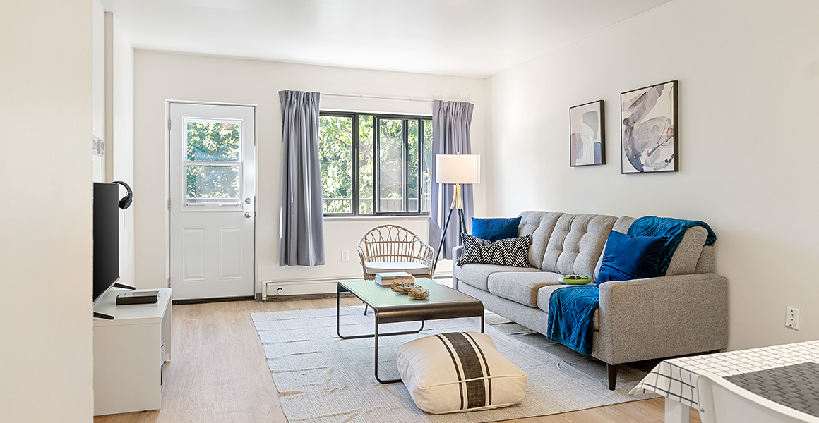 Living room showing couch, coffee table and chair