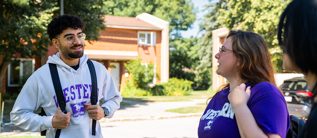 Two students wearing Western gear talking in Platt's Lane