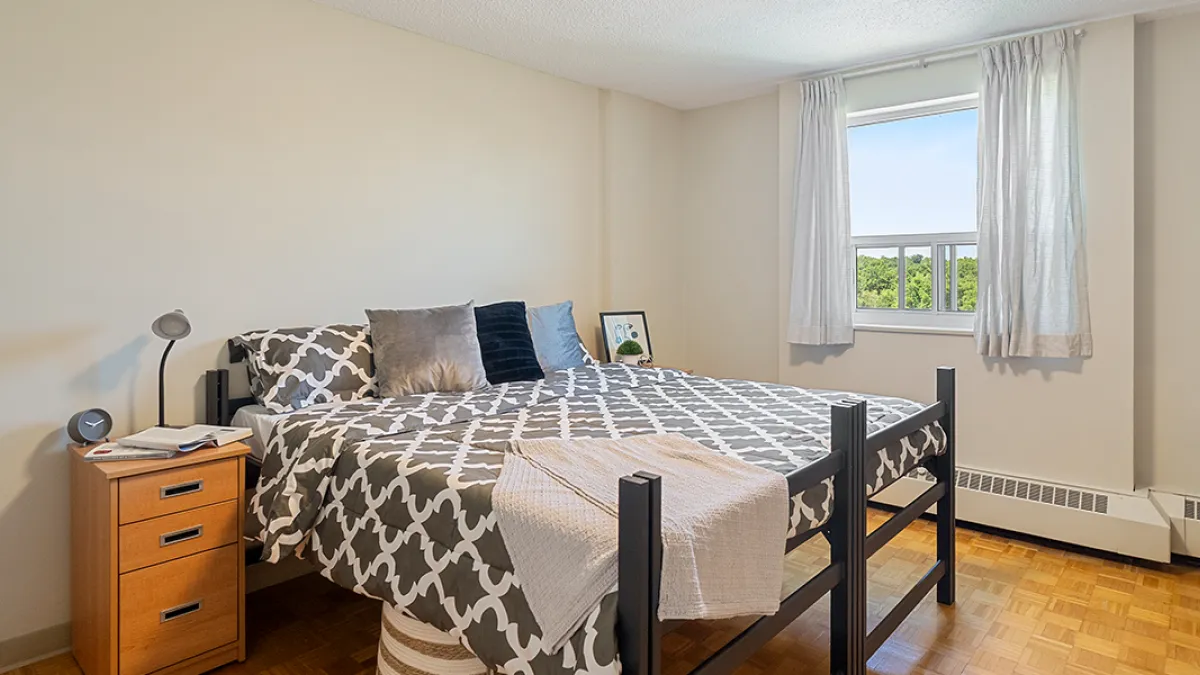 Bedroom showing bed, side table and window