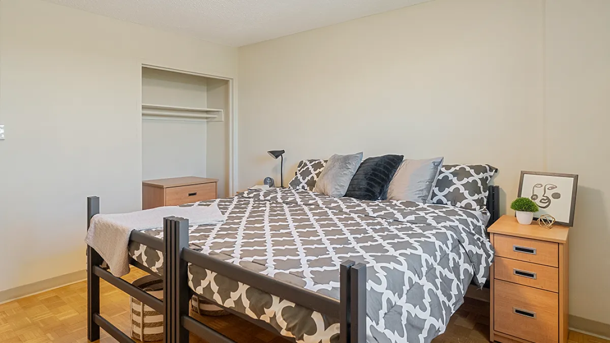 Bedroom showing bed, side table and closet