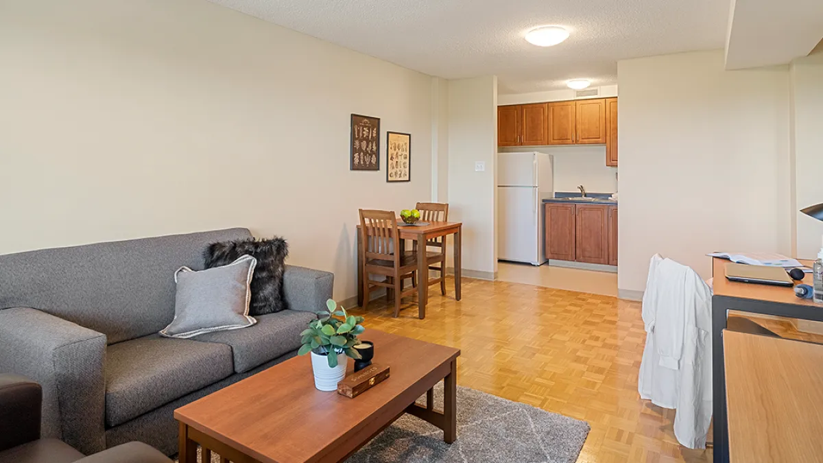 Living room showing couch, coffee table and dining table