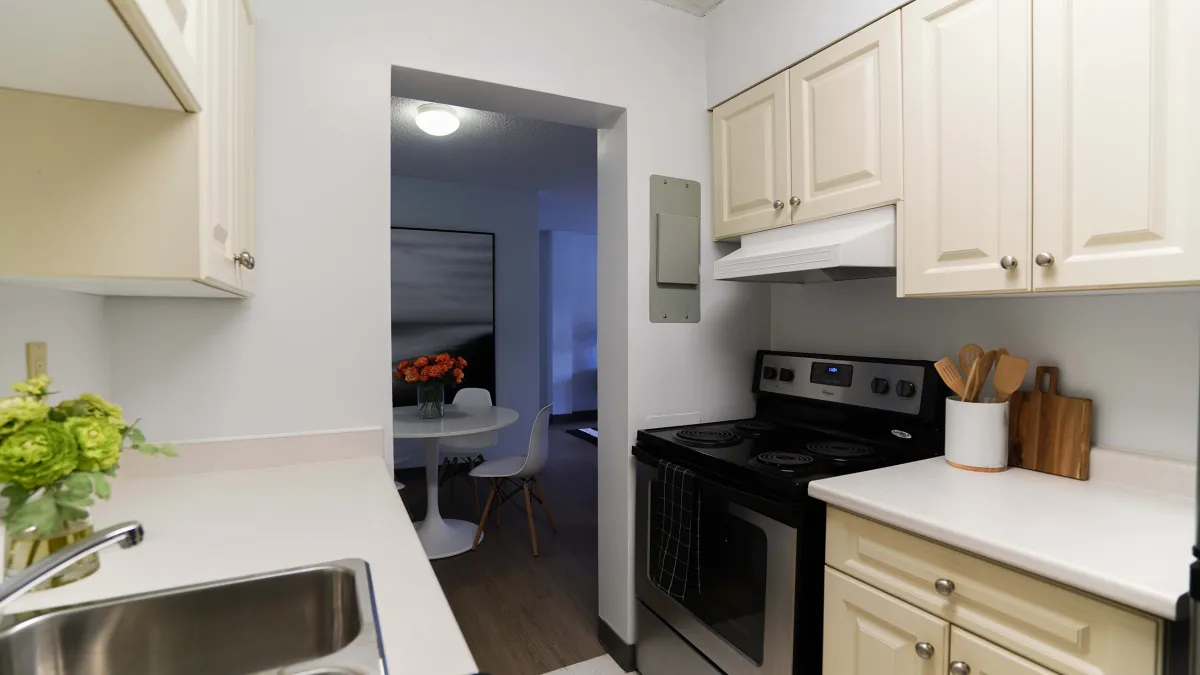 Kitchen showing cabinets, oven and sink