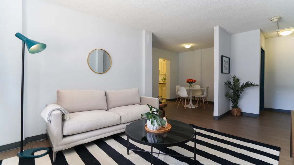 Living room show cable table, couch and looking towards dining area
