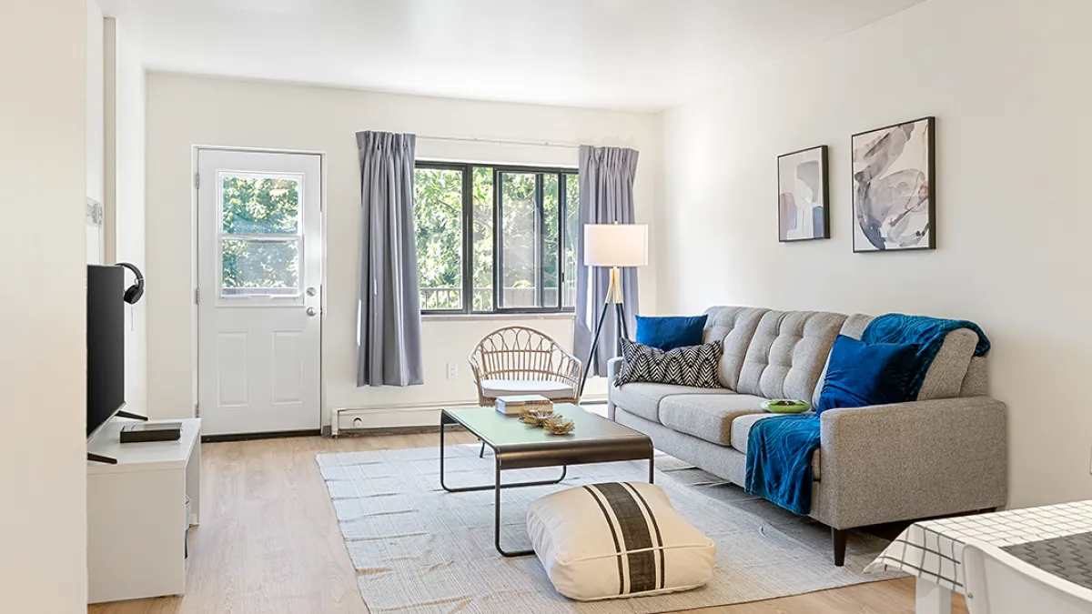 Living room showing couch, coffee table and chair